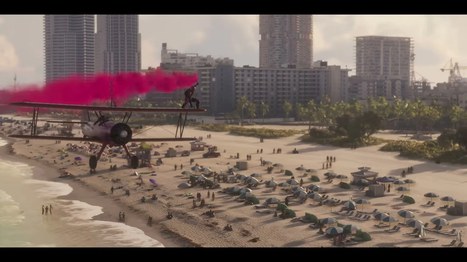 A stunt biplane trailing pink smoke flies low over a crowded Vice City beach, official GTA VI footage