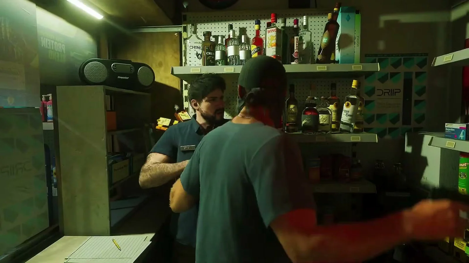 A masked robber grabs a clerk behind the counter of a liquor store, official GTA VI footage